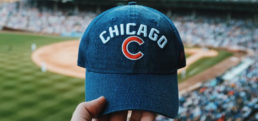 Chicago cubs fan holding a cap at Wrigley Field